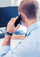 Image showing businessman with smartphone in office