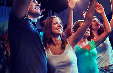 Image showing smiling friends at concert in club