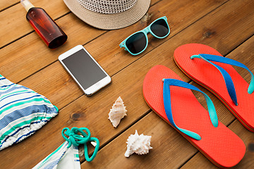 Image showing close up of smartphone and beach stuff