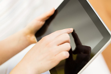 Image showing close up of woman hand with tablet pc at home