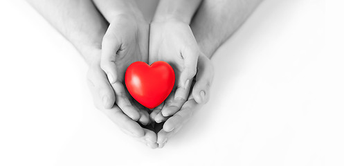 Image showing couple hands holding red heart