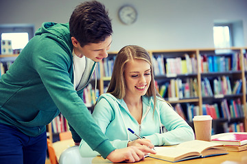 Image showing happy students preparing to exams in library