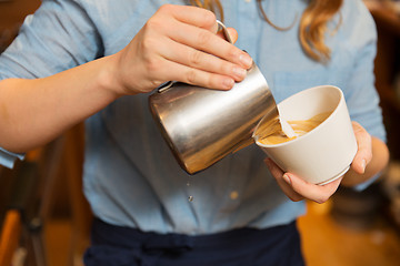 Image showing close up of woman making coffee at shop or cafe