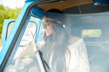 Image showing smiling young hippie woman in minivan car