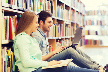 Image showing happy students with laptop in library