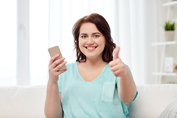 Image showing plus size woman with smartphone showing thumbs up