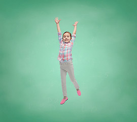 Image showing happy little girl jumping in air over school board