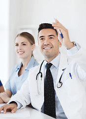 Image showing group of happy doctors on conference at hospital