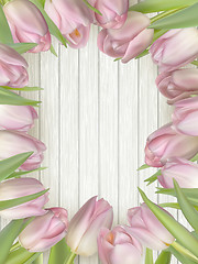 Image showing Bouquet of tulips on a wooden background. EPS 10