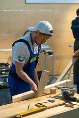 Image showing Young carpenter performs task of competition