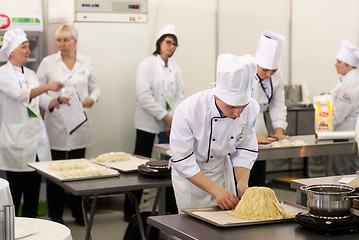 Image showing Cooks prepare food in competition