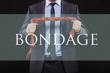 Image showing man in business suit with chained hands. handcuffs for sex games. concept of erotic entertainment. bondage