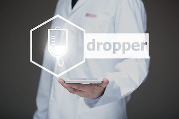 Image showing Doctor working on a virtual screen. medical technology concept. dropper