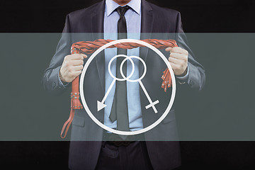Image showing man in business suit with chained hands. handcuffs for sex games. concept of erotic entertainment.