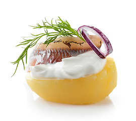 Image showing boiled potato decorated with sour cream, anchovy, onion and dill