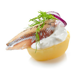 Image showing boiled potato decorated with anchovy, sour cream, dill and onion