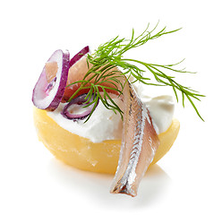 Image showing boiled potato decorated with anchovy, sour cream, dill and onion