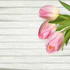 Image showing Pink tulips on wooden background. EPS 10