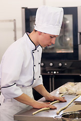 Image showing Young cook prepares food in competition