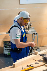 Image showing Young carpenter performs task of competition