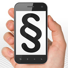 Image showing Law concept: Hand Holding Smartphone with Paragraph on display