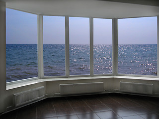 Image showing big office windows with view of marine waves