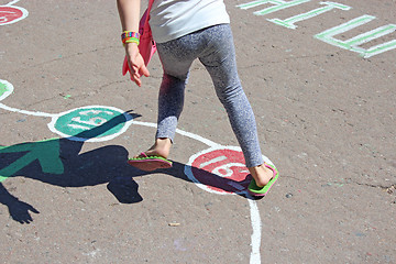 Image showing girl runs on the childish drawings on the asphalt