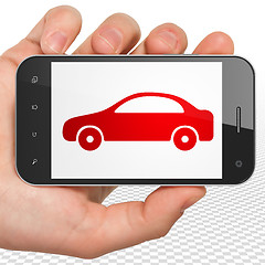 Image showing Travel concept: Hand Holding Smartphone with Car on display