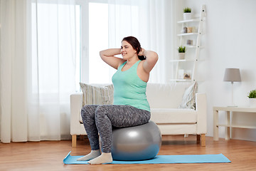 Image showing plus size woman exercising with fitness ball