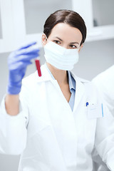 Image showing close up of scientist holding test tube in lab