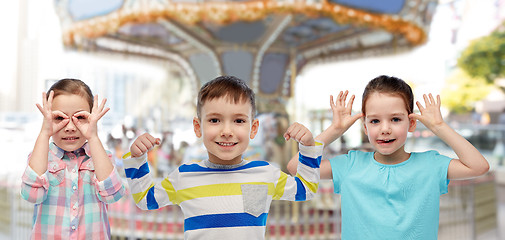 Image showing happy little children having fun over carousel