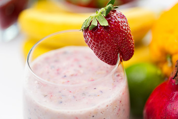 Image showing close up of glass with milk shake and fruits