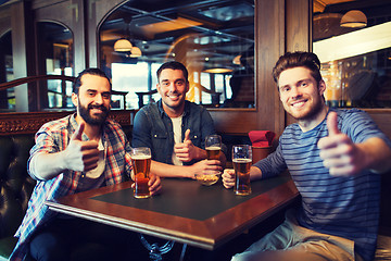 Image showing happy male friends drinking beer at bar or pub