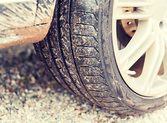 Image showing close up of dirty car wheel on ground