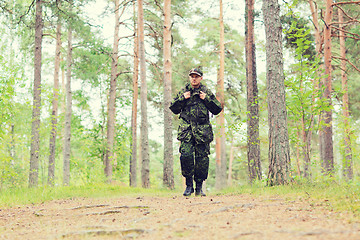 Image showing young soldier with backpack in forest