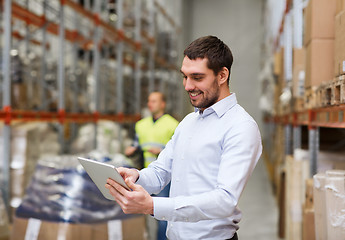 Image showing happy businessman with clipboard at warehouse