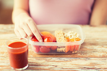 Image showing close up of woman with vegetarian food in box