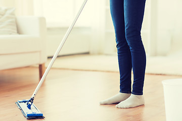 Image showing close up of woman with mop cleaning floor at home