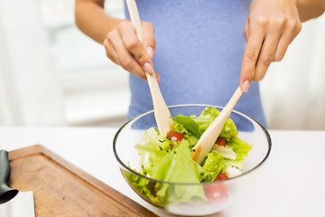 Image showing close up of woman cooking vegetable salad at home