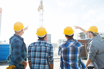 Image showing group of builders in hardhats at construction site