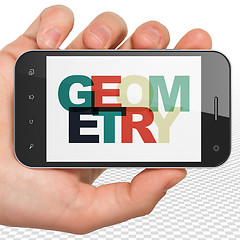 Image showing Learning concept: Hand Holding Smartphone with Geometry on  display