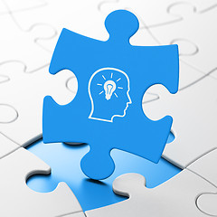 Image showing Studying concept: Head With Lightbulb on puzzle background