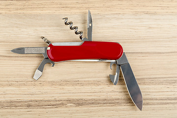 Image showing Multipurpose knife on wooden background