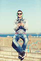 Image showing happy young man with tablet pc and headphones