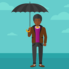 Image showing Businessman standing with umbrella.