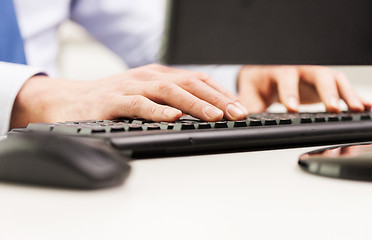 Image showing close up of businessman hands typing on keyboard