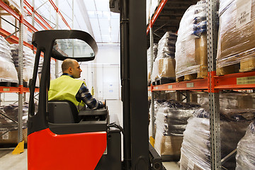 Image showing man on forklift loading cargo at warehouse