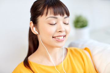 Image showing happy asian woman with earphones listening music