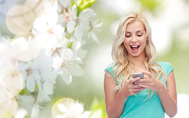 Image showing happy young woman or teenage girl with smartphone