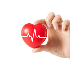 Image showing close up of hand with cardiogram on red heart